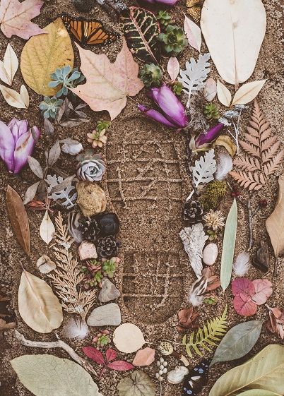 Flowers and leaves on sand with shoe pri